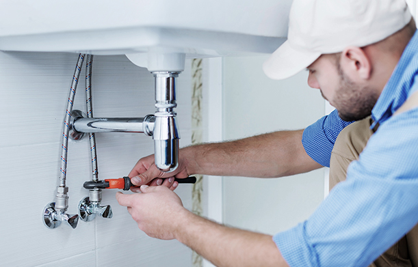 Plumber fixing a tap